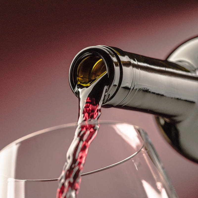 Pouring red wine from a bottle into a wineglass